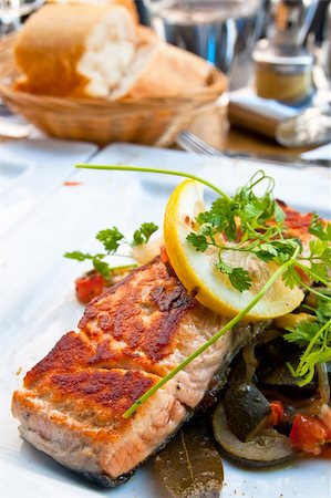 poached salmon - grilled salmon and lemon - french cuisine dish with tomato and salmon Stock Photo - Budget Royalty-Free & Subscription, Code: 400-05330101