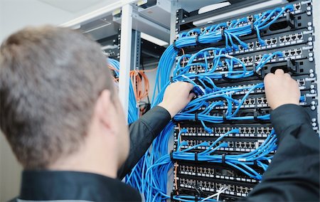 server room managers - young it engineer in datacenter server room Stock Photo - Budget Royalty-Free & Subscription, Code: 400-05331650