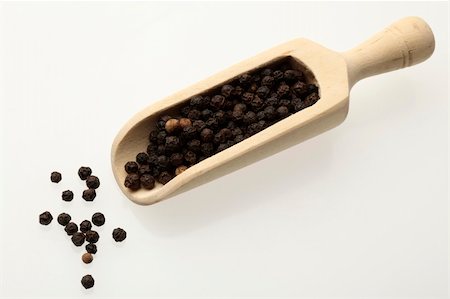 simsearch:700-00342851,k - black peppercorns on a wooden spoon over white Photographie de stock - Aubaine LD & Abonnement, Code: 400-05332851