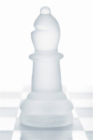 simsearch:400-04383941,k - glass chess bishop is standing on board, cut out from white background Photographie de stock - Aubaine LD & Abonnement, Code: 400-05332880