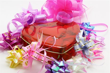 Heart shaped gift box surrounded by colorful ribbons Stock Photo - Budget Royalty-Free & Subscription, Code: 400-05332892