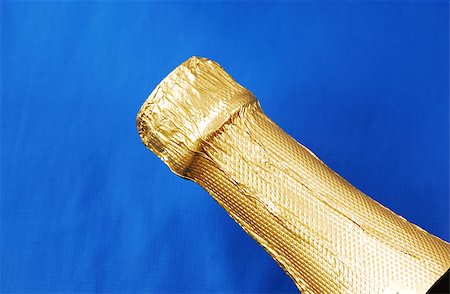 Close up view of a champagne bottle isolated on blue Stock Photo - Budget Royalty-Free & Subscription, Code: 400-05344129