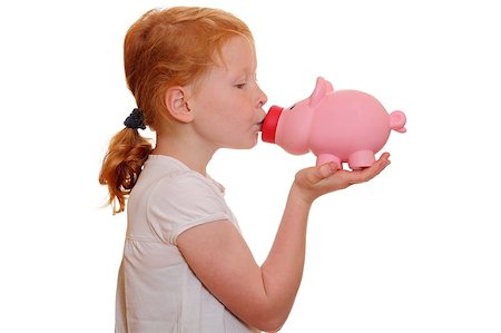 Portrait of a red haired girl kissing her piggy bank on white background Stock Photo - Budget Royalty-Free & Subscription, Code: 400-05344181