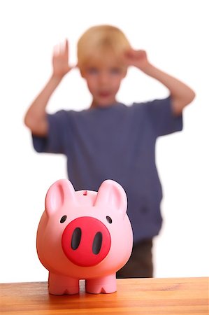 A pink piggy bank on front of a young boy Stock Photo - Budget Royalty-Free & Subscription, Code: 400-05344192