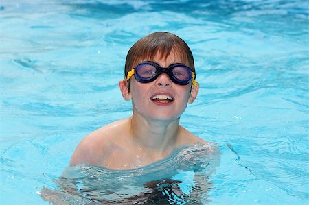 Laughing smiling young boy in blue water of the swimming pool Stock Photo - Budget Royalty-Free & Subscription, Code: 400-05344212