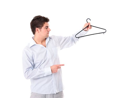 A portrait of a young man holding a hanger over white background Stock Photo - Budget Royalty-Free & Subscription, Code: 400-05344523