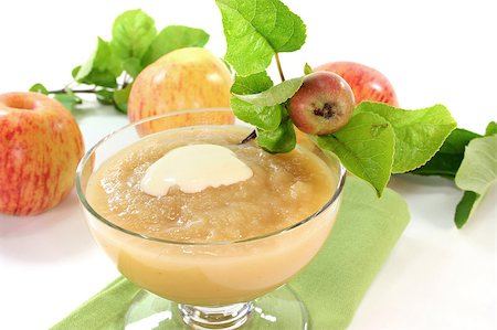 Applesauce with vanilla sauce and fresh apple with leaves on a white background Stock Photo - Budget Royalty-Free & Subscription, Code: 400-05344530