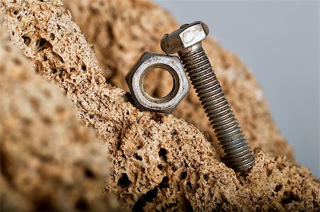 Metal bolt pushing a nut on mountain Stock Photo - Budget Royalty-Free & Subscription, Code: 400-05345128