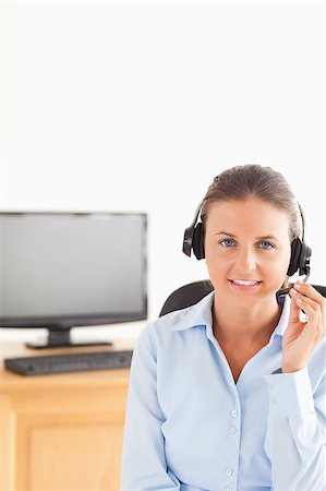 simsearch:400-04472832,k - Smiling secretary wearing a headset in her office Stock Photo - Budget Royalty-Free & Subscription, Code: 400-05345133