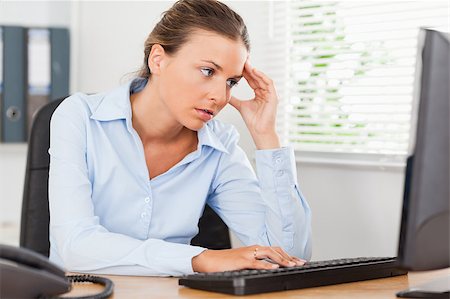 phone with pain - A frustrated businesswoman is looking to the screen of her pc in an office Stock Photo - Budget Royalty-Free & Subscription, Code: 400-05345157