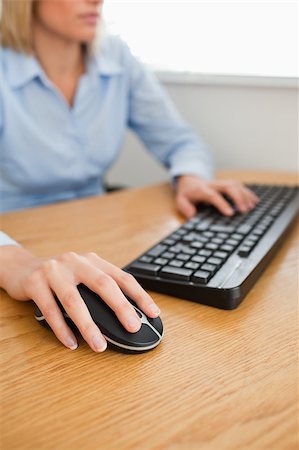 Blonde businesswoman with hands on mouse and keyboard in her office Stock Photo - Budget Royalty-Free & Subscription, Code: 400-05345286