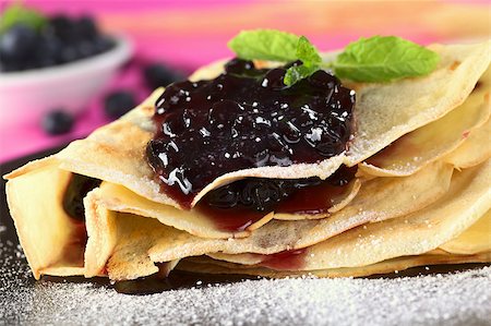 Folded pancake filled with blueberry jam and sugar powder on top (Selective Focus, Focus on the front of the jam filling) Stock Photo - Budget Royalty-Free & Subscription, Code: 400-05345508