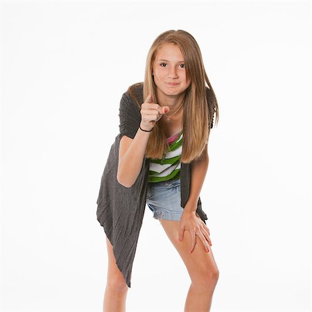 eye pointing - A happy active pretty teenage female girl pointing isolated against a white background. Stock Photo - Budget Royalty-Free & Subscription, Code: 400-05345756