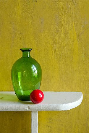 still-life with bottle and red ball on yellow background Stock Photo - Budget Royalty-Free & Subscription, Code: 400-05345887