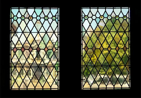 The view through two stained glass windows in the landmark Bruges Town Hall. The background of a building and tree in Burg Square is rendered in indistinct, almost impressionistic tones, through distortions from the old panes. Stock Photo - Budget Royalty-Free & Subscription, Code: 400-05345974