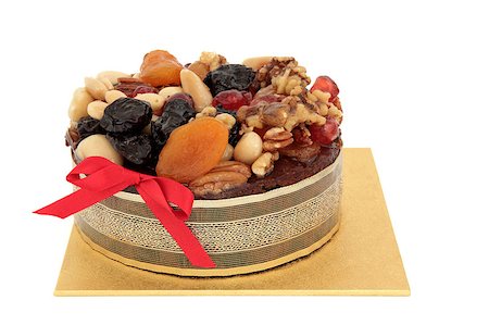 decoration in brazil - Luxury christmas cake with glazed fruit and ribbon on a gold base over white background. Stock Photo - Budget Royalty-Free & Subscription, Code: 400-05346418