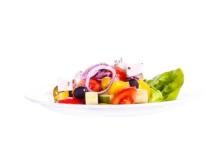 simsearch:400-05346545,k - Greek salad on a plate. On a white background. Fotografie stock - Microstock e Abbonamento, Codice: 400-05346545