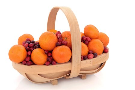 fruit winter basket - Cranberry and mandarin christmas fruit arrangement in a rustic wooden basket isolated over white background. Stock Photo - Budget Royalty-Free & Subscription, Code: 400-05346622