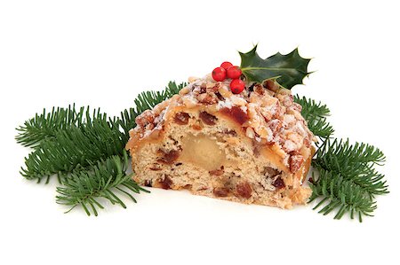 Stollen christmas cake with holly berry and blue pine fir leaf sprigs isolated over white background. Stock Photo - Budget Royalty-Free & Subscription, Code: 400-05346632