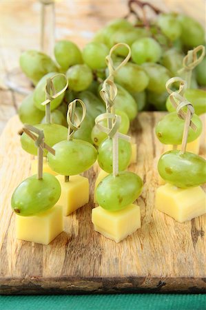 fruit skewers for cocktails - appetizer canape cheese with white grapes on bamboo skewers Stock Photo - Budget Royalty-Free & Subscription, Code: 400-05346695