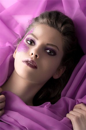simsearch:400-04420197,k - beauty face shot of a young gir with glitter make up in her face laying between purple silk sheets Stock Photo - Budget Royalty-Free & Subscription, Code: 400-05346751