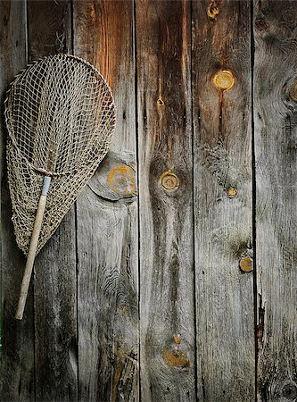 An old fishing net hanging on rustic wooden wall Stock Photo - Budget Royalty-Free & Subscription, Code: 400-05346905