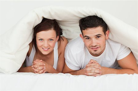 simsearch:400-04182849,k - Happy couple hiding under their bvlanket in the bedroom Stock Photo - Budget Royalty-Free & Subscription, Code: 400-05347148