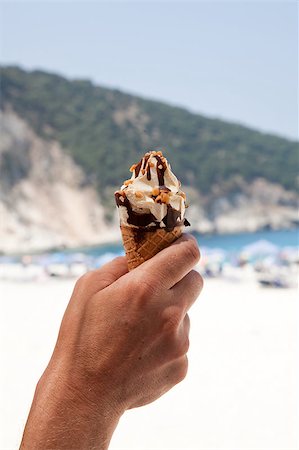 Holding a delicious ice cream at the beach. Stock Photo - Budget Royalty-Free & Subscription, Code: 400-05347216