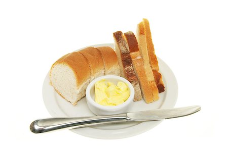 Selection of bread with butter and a knife on a plate Stock Photo - Budget Royalty-Free & Subscription, Code: 400-05347360