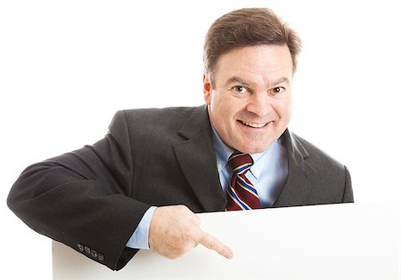 simsearch:400-05347520,k - Businessman leaning over blank white space, pointing, with a big smile. Photographie de stock - Aubaine LD & Abonnement, Code: 400-05347517