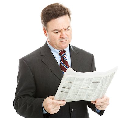 simsearch:400-05347520,k - Businessman reading bad news in the newspaper.  Could be financial or political news.  Isolated on white. Photographie de stock - Aubaine LD & Abonnement, Code: 400-05347519