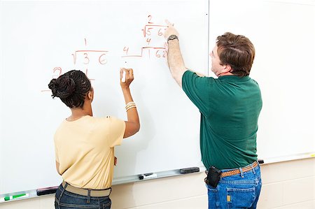 High school student and teacher at the white board doing long division.  Focus on the equations. Stock Photo - Budget Royalty-Free & Subscription, Code: 400-05347527