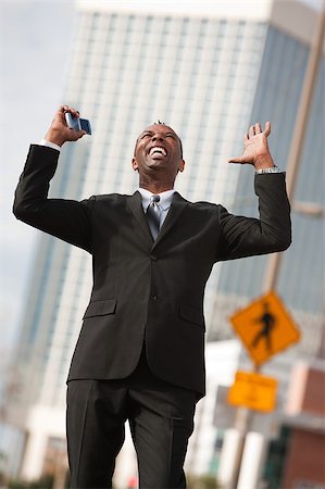 Excited African-American businessman with raised arms Stock Photo - Budget Royalty-Free & Subscription, Code: 400-05347571