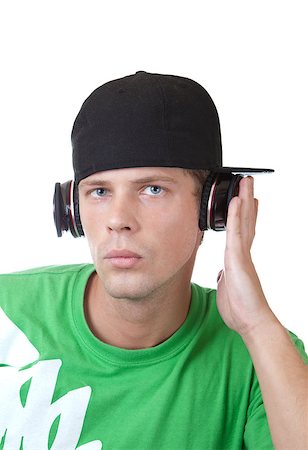 style boy listen music - Young man playing music through headphones Stock Photo - Budget Royalty-Free & Subscription, Code: 400-05347689