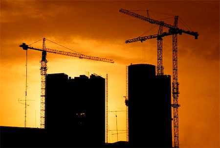 simsearch:400-05074551,k - Construction site at sunset with two unfinished buildings framed by two cranes Foto de stock - Royalty-Free Super Valor e Assinatura, Número: 400-05347946