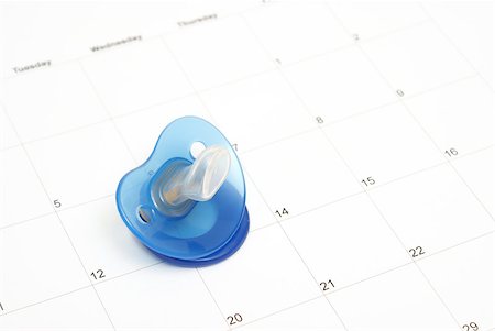 pacifier nobody - A babies pacifier on a calendar to conceptualize on many maternity ideas. Stock Photo - Budget Royalty-Free & Subscription, Code: 400-05348388