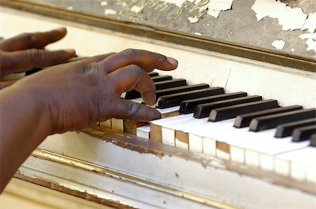 Musician is playing on a very old piano Stock Photo - Budget Royalty-Free & Subscription, Code: 400-05348430