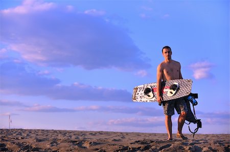 surfers men model - Portrait of a strong young  surf  man at beach on sunset in a contemplative mood with a surfboard Stock Photo - Budget Royalty-Free & Subscription, Code: 400-05348628