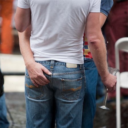 prinsengracht - Rear view of a gay couple visiting the Amsterdam Gay Pride 2011 Stockbilder - Microstock & Abonnement, Bildnummer: 400-05348783