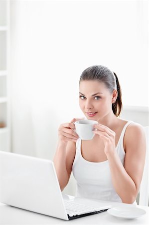 A beautiful girl with a cup and a laptop Stock Photo - Budget Royalty-Free & Subscription, Code: 400-05348825