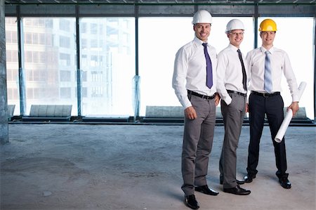 Young men in shirts and helmets on a construction site Stock Photo - Budget Royalty-Free & Subscription, Code: 400-05348860