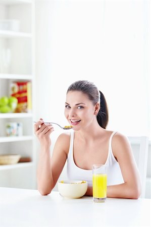 Beautiful young girl ate breakfast in the kitchen Stock Photo - Budget Royalty-Free & Subscription, Code: 400-05348876