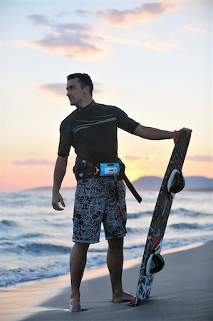 surfers men model - Portrait of a strong young  surf  man at beach on sunset in a contemplative mood with a surfboard Stock Photo - Budget Royalty-Free & Subscription, Code: 400-05348965