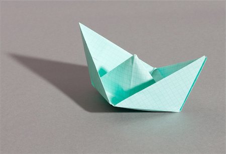 paper boat - Paper ship, photo on the grey background Stock Photo - Budget Royalty-Free & Subscription, Code: 400-05349076