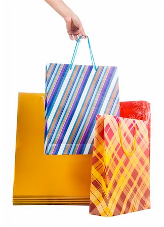 Female hand holding colorful shopping bags on white Photographie de stock - Aubaine LD & Abonnement, Code: 400-05349232