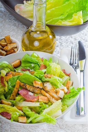 fresh homemade classic ceasar salad ,closeup over a fine embroidery table cover Stock Photo - Budget Royalty-Free & Subscription, Code: 400-05349262
