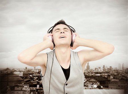Teenager listening music on headphones :NOTE:Grain and texture was added Stock Photo - Budget Royalty-Free & Subscription, Code: 400-05349451