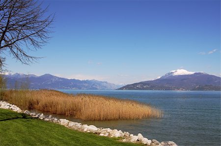 simsearch:400-07550315,k - View on Lake Garda and mountains with snow on the edge from promenade in Sirmione, Italy. Stock Photo - Budget Royalty-Free & Subscription, Code: 400-05349972