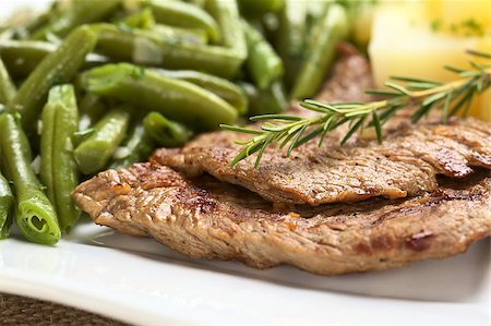 simsearch:400-04855321,k - Beef meat slices with fresh rosemary on top, served with green beans and cooked potatoes (Selective Focus, Focus on the front of the upper meat slice and the front of the rosemary) Stock Photo - Budget Royalty-Free & Subscription, Code: 400-05340081