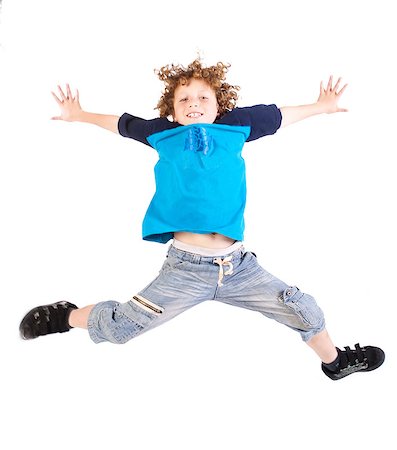 simsearch:400-06795514,k - Attractive young kid jumping high, indoors. Photographie de stock - Aubaine LD & Abonnement, Code: 400-05340467